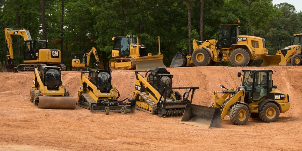 yellow CAT rental equipment on a hill of dirt